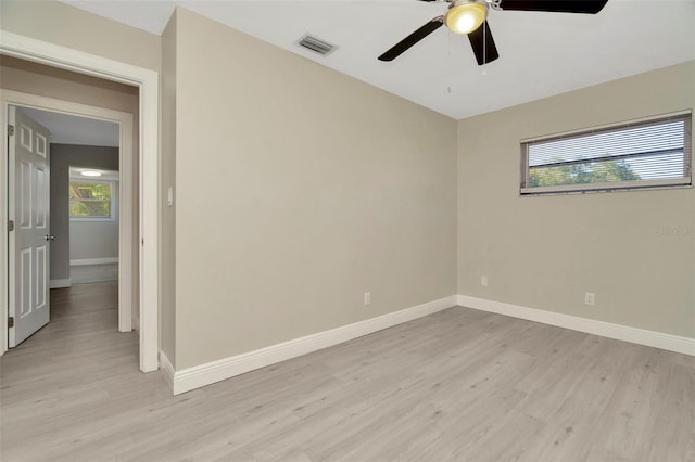 7323 Andre Dr, Zephyrhills, FL 33541 - empty room with light wood-style flooring, baseboards, ceiling fan, and visible vents