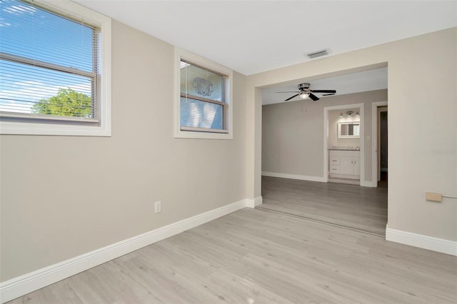 7323 Andre Dr, Zephyrhills, FL 33541 - unfurnished room featuring baseboards, light wood-style flooring, visible vents, and ceiling fan