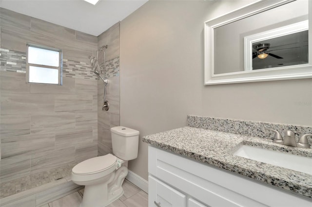 7323 Andre Dr, Zephyrhills, FL 33541 - bathroom with vanity, a tile shower, toilet, baseboards, and ceiling fan