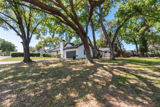 2715 Willow Oaks Dr, Valrico, FL 33594 - view of green lawn featuring an attached garage
