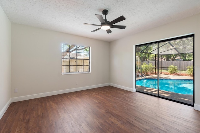 2715 Willow Oaks Dr, Valrico, FL 33594 - spare room with wood finished floors, baseboards, healthy amount of natural light, and a textured ceiling