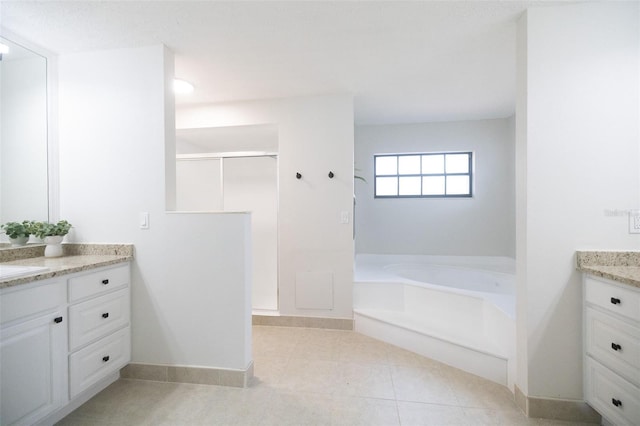 2715 Willow Oaks Dr, Valrico, FL 33594 - bathroom featuring vanity, a shower stall, a bath, tile patterned flooring, and baseboards