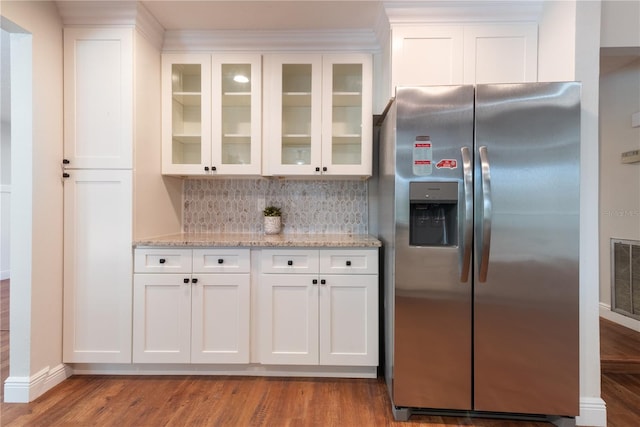 2715 Willow Oaks Dr, Valrico, FL 33594 - kitchen with stainless steel refrigerator with ice dispenser, white cabinetry, and light stone counters