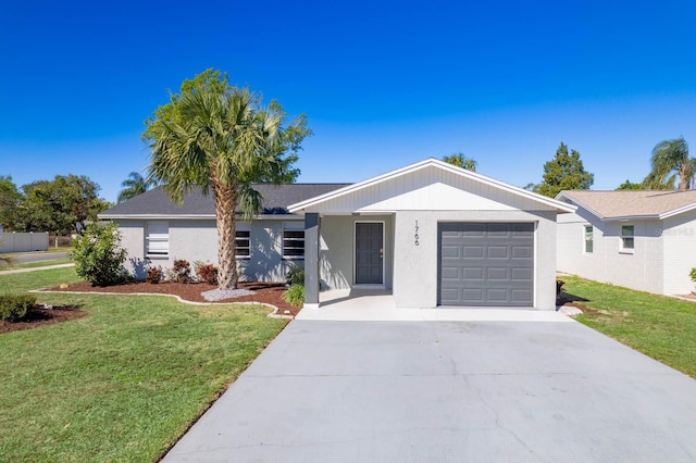 ranch-style house with a garage, concrete driveway, a front lawn, and stucco siding
