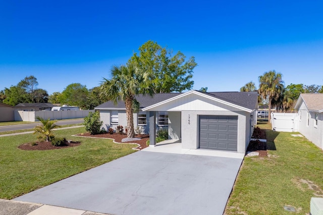 ranch-style home with fence, concrete driveway, a front yard, a garage, and a gate