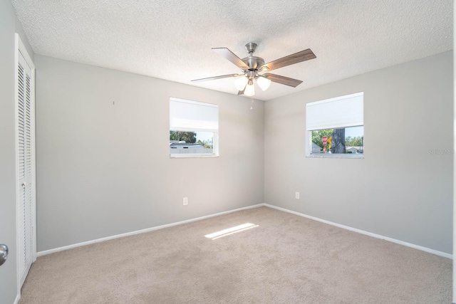 unfurnished bedroom featuring a closet, multiple windows, baseboards, and carpet