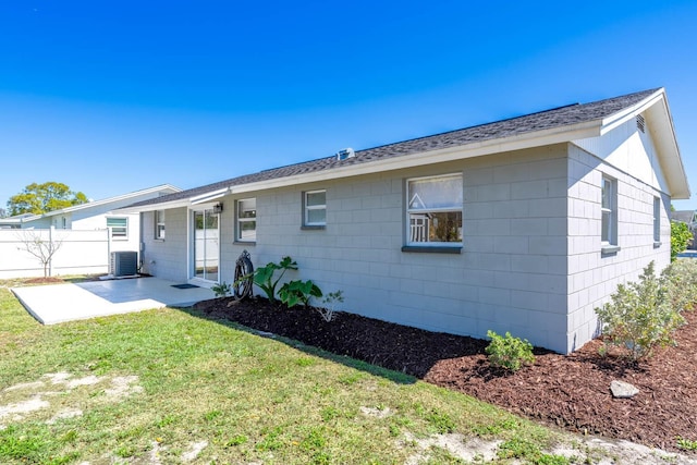 back of house with a patio, central air condition unit, a yard, and fence