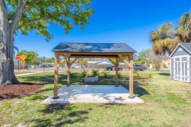 view of yard featuring a gazebo, a storage unit, a patio, and an outdoor structure