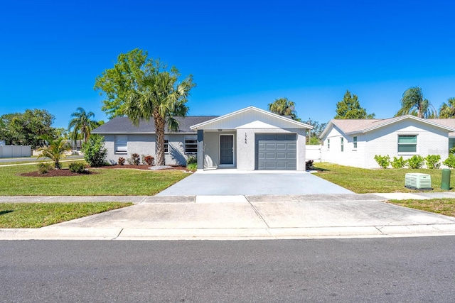 ranch-style house with an attached garage, concrete driveway, and a front yard