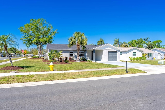 ranch-style house with a garage, concrete driveway, a front lawn, and stucco siding