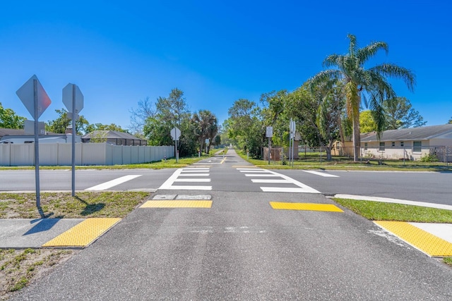 view of road featuring traffic signs and a residential view