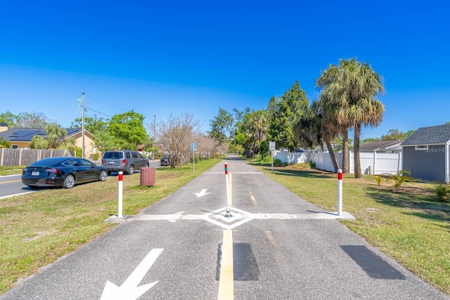 view of road featuring traffic signs and a residential view