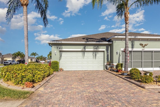 689 Chipper Dr, Sun City Center, FL 33573 - garage featuring decorative driveway