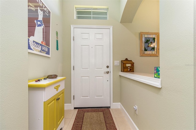 689 Chipper Dr, Sun City Center, FL 33573 - entryway featuring tile patterned floors and baseboards
