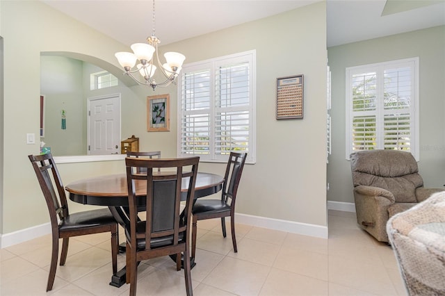 689 Chipper Dr, Sun City Center, FL 33573 - dining area featuring a wealth of natural light, baseboards, arched walkways, and a chandelier