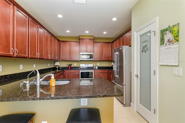 689 Chipper Dr, Sun City Center, FL 33573 - kitchen with dark brown cabinets, recessed lighting, a peninsula, stainless steel appliances, and a sink