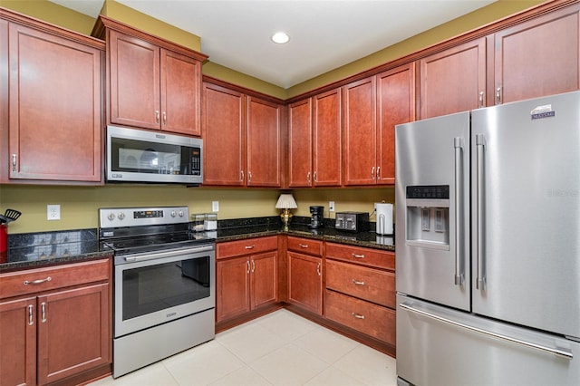 689 Chipper Dr, Sun City Center, FL 33573 - kitchen featuring recessed lighting, stainless steel appliances, light tile patterned floors, and dark stone counters