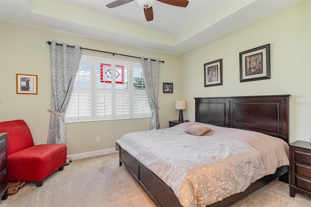 689 Chipper Dr, Sun City Center, FL 33573 - bedroom with baseboards, a raised ceiling, carpet floors, and ceiling fan