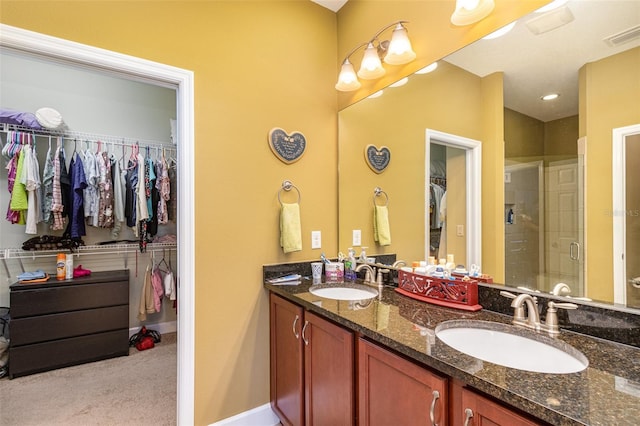 689 Chipper Dr, Sun City Center, FL 33573 - full bath with a spacious closet, visible vents, a stall shower, and a sink