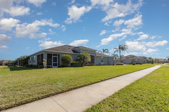 689 Chipper Dr, Sun City Center, FL 33573 - view of front of home with a front yard and a sunroom