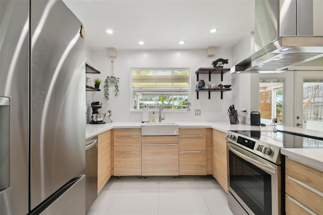 kitchen with a sink, stainless steel appliances, wall chimney range hood, and open shelves