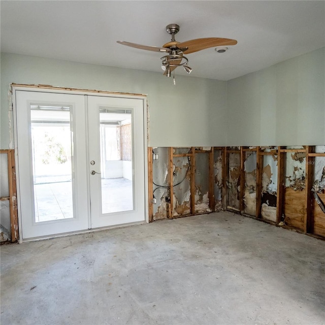 miscellaneous room featuring french doors, concrete floors, and ceiling fan