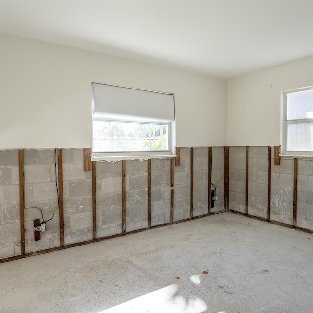 empty room featuring concrete block wall