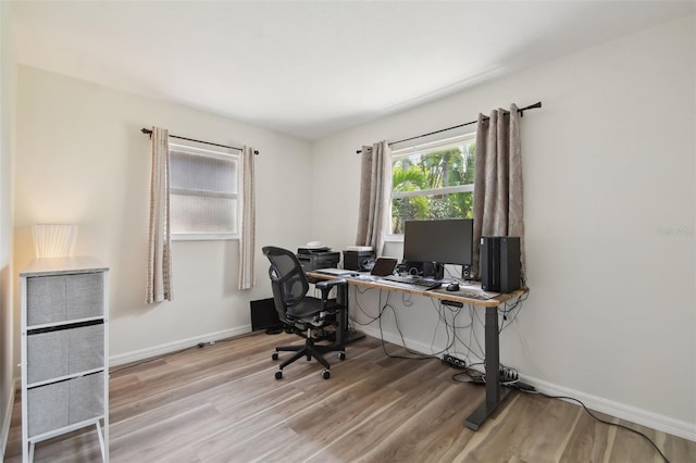 office area featuring light wood-type flooring and baseboards