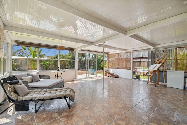 sunroom with beamed ceiling and a healthy amount of sunlight