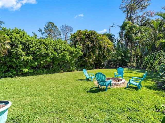 13420 Rustic Pines Blvd S, Seminole, FL 33776 - view of grassy yard featuring an outdoor fire pit