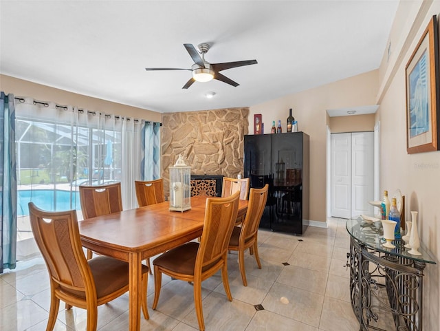 13420 Rustic Pines Blvd S, Seminole, FL 33776 - dining area with ceiling fan, light tile patterned floors, and a stone fireplace