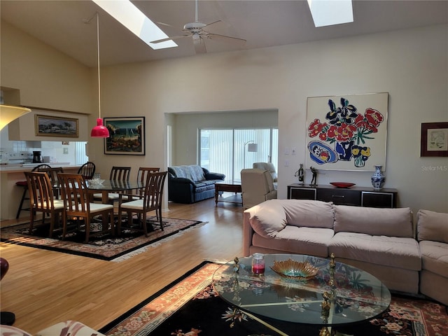 7392 Meadow Brook Ln, Spring Hill, FL 34606 - living area with a skylight, wood finished floors, ceiling fan, and high vaulted ceiling