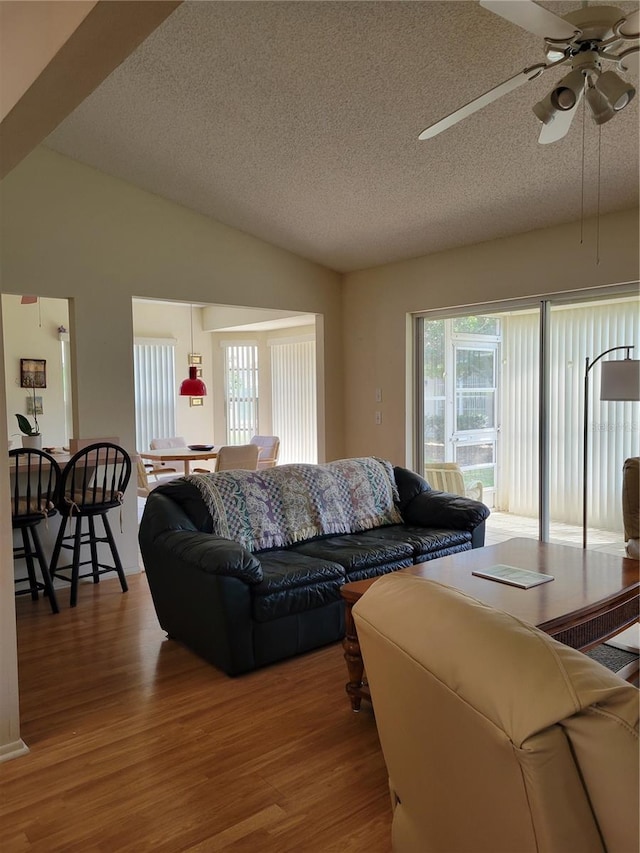 7392 Meadow Brook Ln, Spring Hill, FL 34606 - living area with a textured ceiling, wood finished floors, lofted ceiling, and a ceiling fan