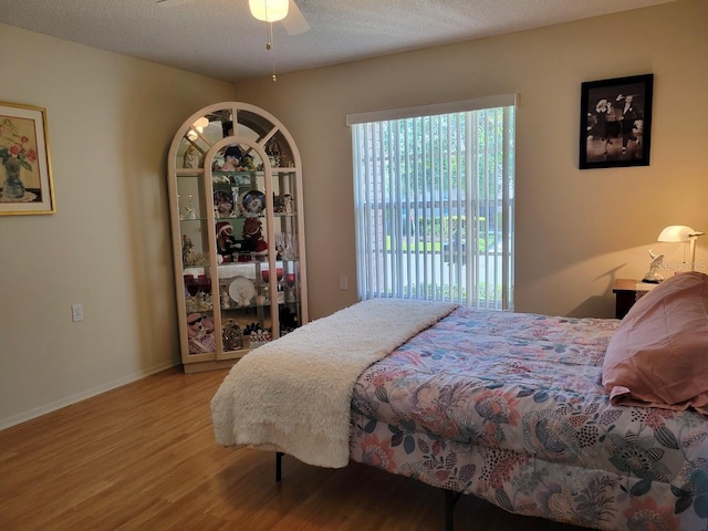 7392 Meadow Brook Ln, Spring Hill, FL 34606 - bedroom with wood finished floors, access to exterior, baseboards, and a ceiling fan