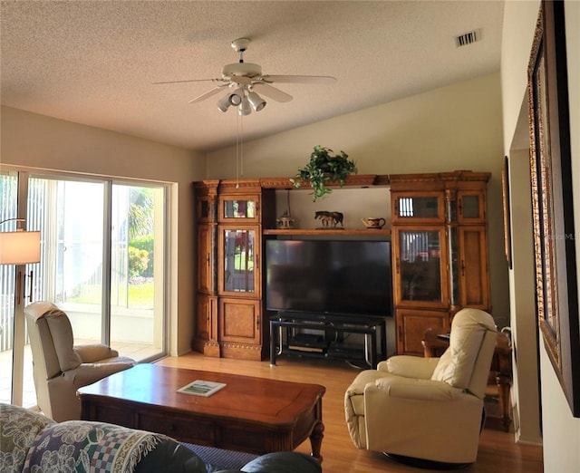 7392 Meadow Brook Ln, Spring Hill, FL 34606 - living area with ceiling fan, wood finished floors, vaulted ceiling, and a textured ceiling