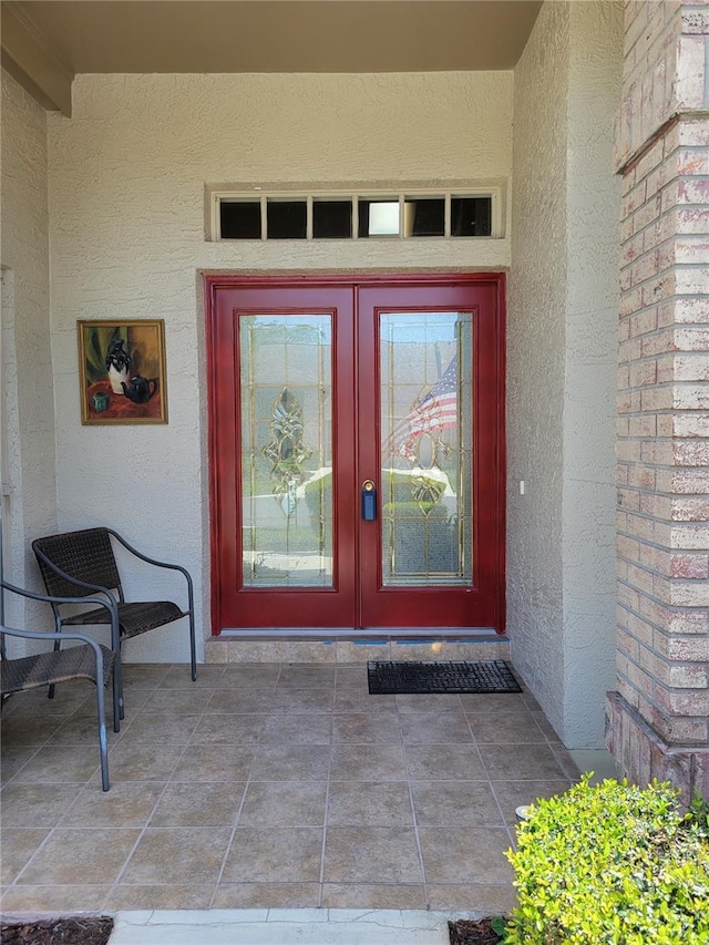 7392 Meadow Brook Ln, Spring Hill, FL 34606 - view of exterior entry featuring stucco siding and french doors