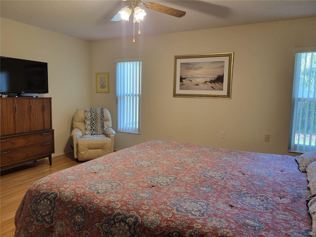 7392 Meadow Brook Ln, Spring Hill, FL 34606 - bedroom with multiple windows, light wood-style flooring, and a ceiling fan