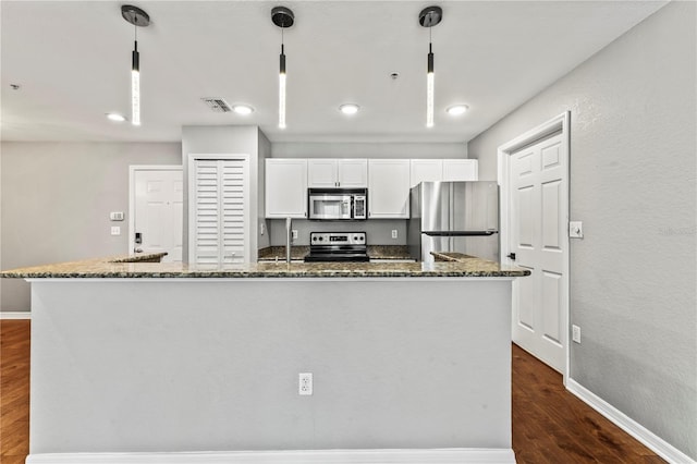 700 S Harbour Island Blvd Unit 240, Tampa, FL 33602 - kitchen featuring visible vents, dark wood-type flooring, dark stone countertops, appliances with stainless steel finishes, and white cabinets