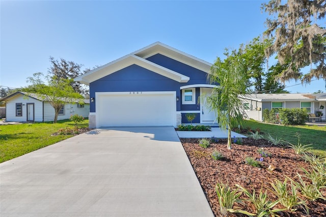view of front of house with concrete driveway, a garage, a front yard, and stucco siding