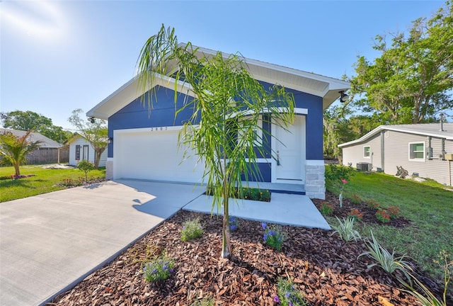 view of front of house with stucco siding, central AC, concrete driveway, and a front lawn