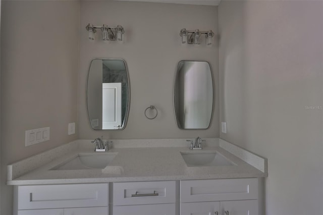 full bathroom with double vanity and a sink