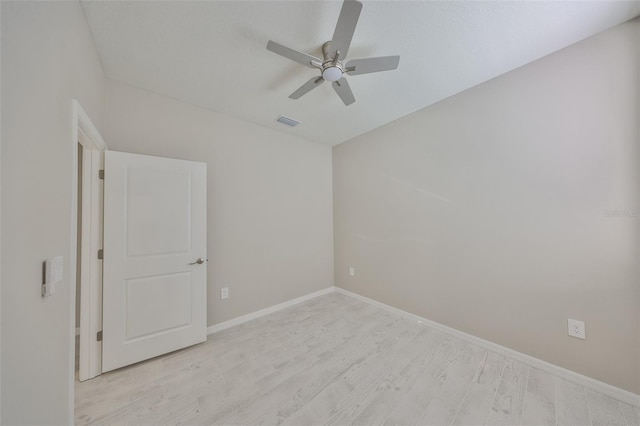 unfurnished room featuring visible vents, baseboards, light wood finished floors, and ceiling fan