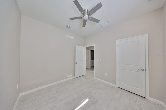 unfurnished bedroom featuring light wood finished floors, visible vents, ceiling fan, and baseboards