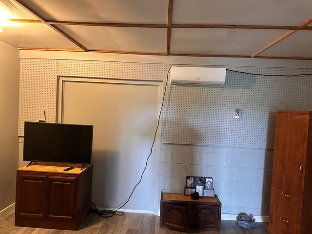 5562 S US-301, Bushnell, FL 33513 - bedroom featuring a wall mounted air conditioner, wallpapered walls, and wood finished floors
