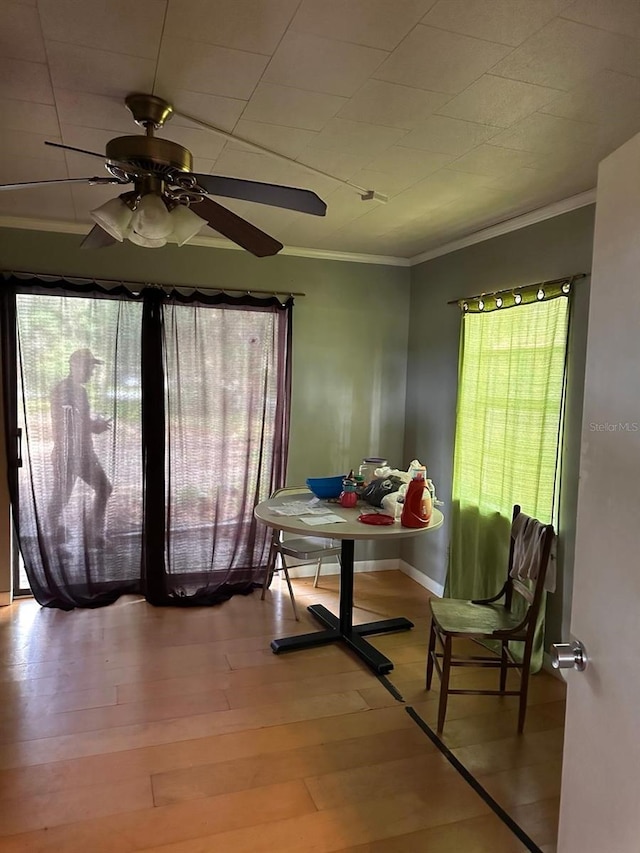 5562 S US-301, Bushnell, FL 33513 - dining space featuring a healthy amount of sunlight, wood finished floors, a ceiling fan, and ornamental molding
