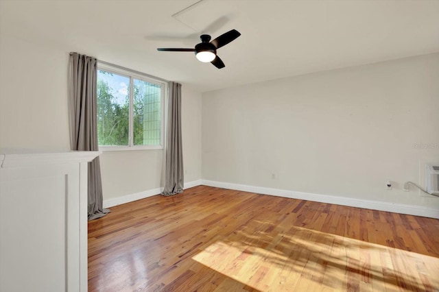 1301 S Howard Ave Unit B24, Tampa, FL 33606 - unfurnished room featuring wood finished floors, baseboards, and a ceiling fan