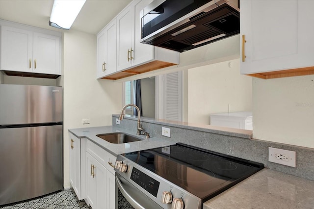 1301 S Howard Ave Unit B24, Tampa, FL 33606 - kitchen featuring white cabinets, light stone countertops, stainless steel appliances, and a sink