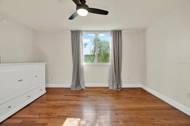 1301 S Howard Ave Unit B24, Tampa, FL 33606 - unfurnished bedroom featuring light wood-type flooring, a ceiling fan, and baseboards
