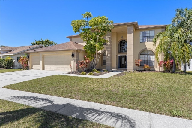 view of front of property with a front yard, concrete driveway, a garage, and stucco siding