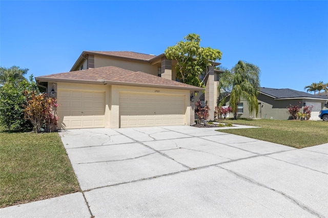 view of front of property featuring a shingled roof, concrete driveway, a front yard, stucco siding, and a garage